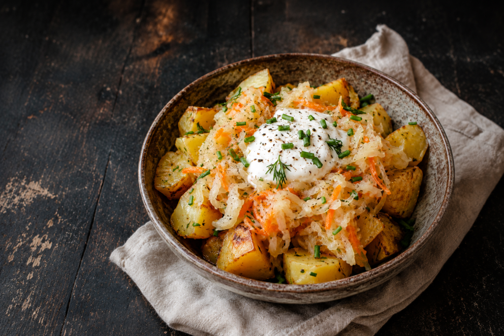 Warm potato bowl with fermented cabbage, carrot & sour cream